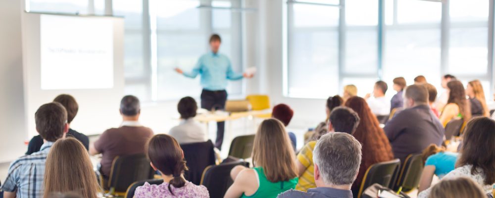 Speaker at business workshop and presentation. Audience at the conference room.